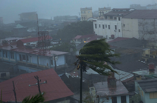 The high winds of Hurricane Matthew roar over Baracoa, Cuba, Tuesday, Oct. 4, 2016. The dangerous Category 4 storm blew ashore around dawn in Haiti. It unloaded heavy rain as it swirled on toward a lightly populated part of Cuba and the Bahamas. (AP Photo/Ramon Espinosa)